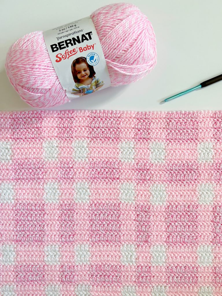 crochet pink plaid blanket with hook and yarn