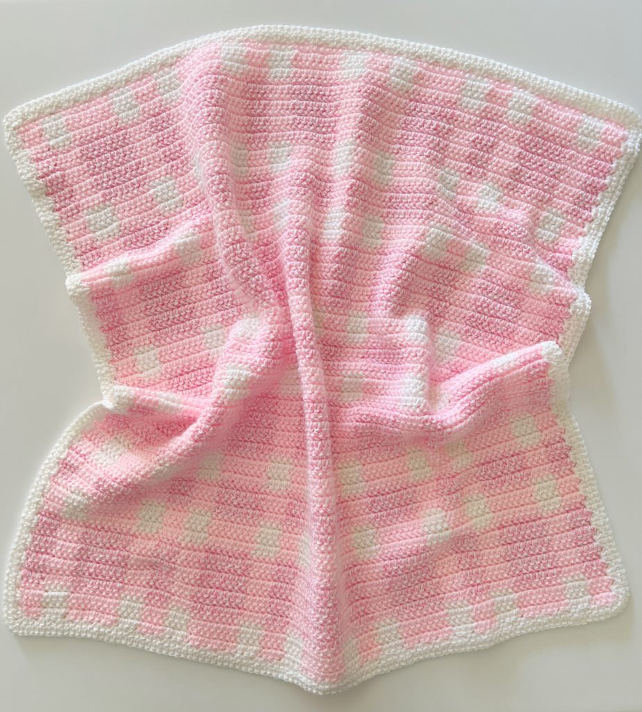crochet pink plaid baby blanket laying flat