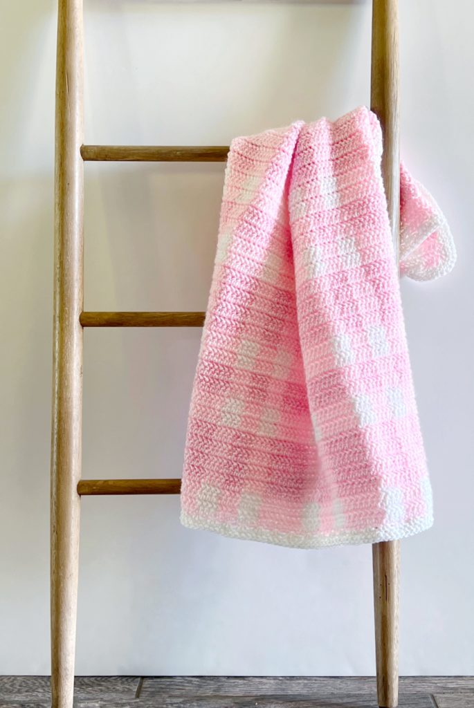 crochet pink plaid baby blanket on ladder