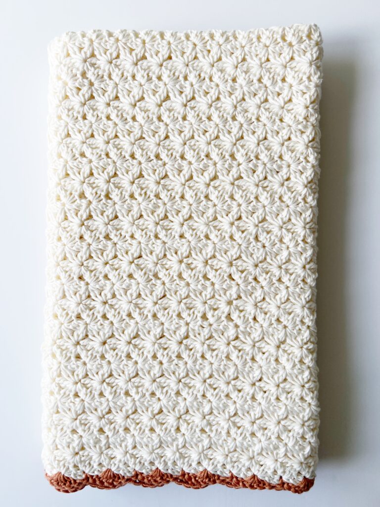 folded lengthwise crochet cream flower blanket