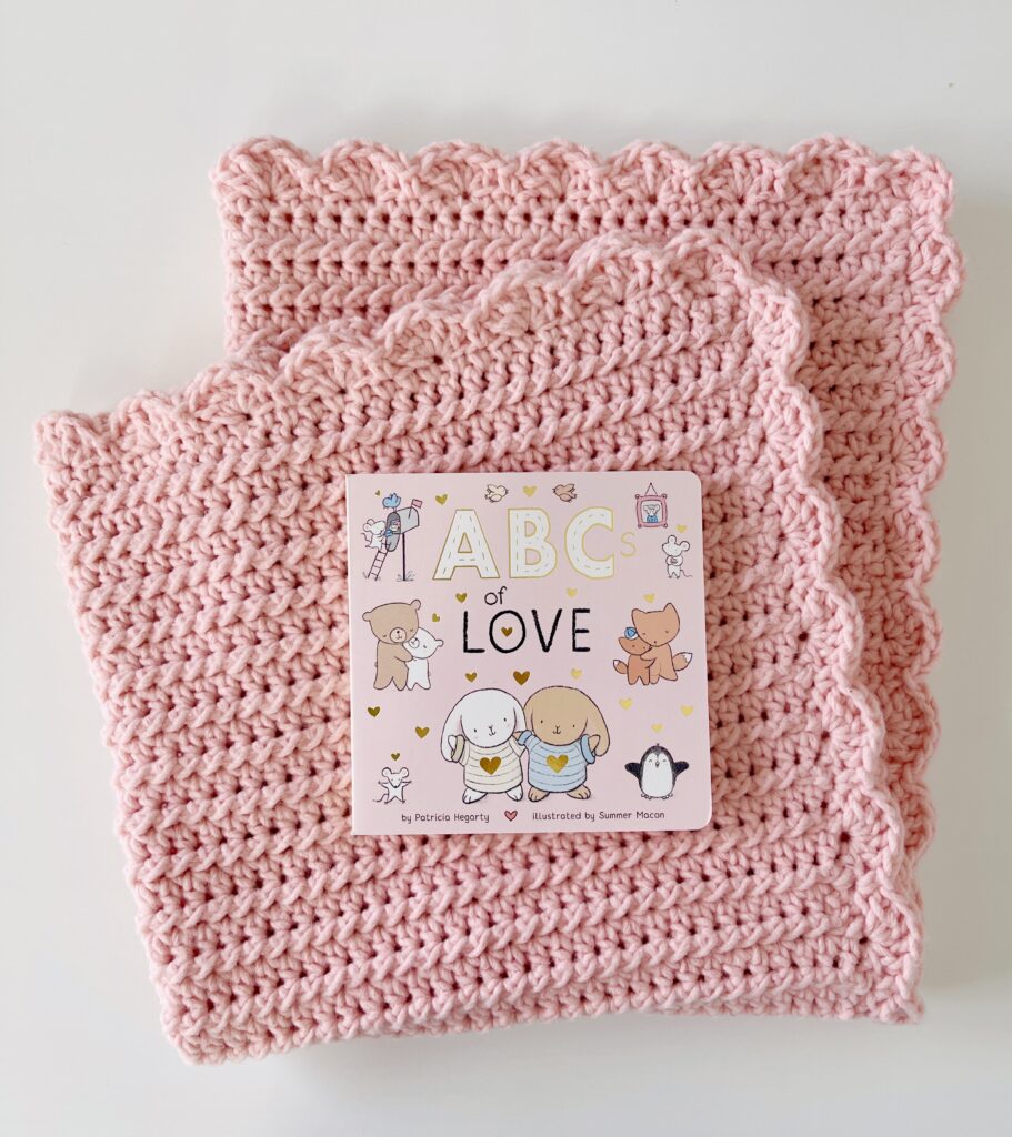 pink baby blanket with picture book
