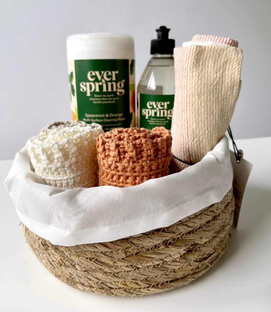 crochet dishcloths in basket with cleaning supplies