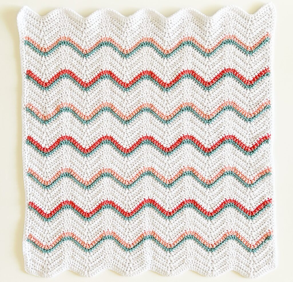crochet white ripple blanket with colorful stripes