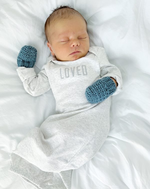 baby with crochet mittens