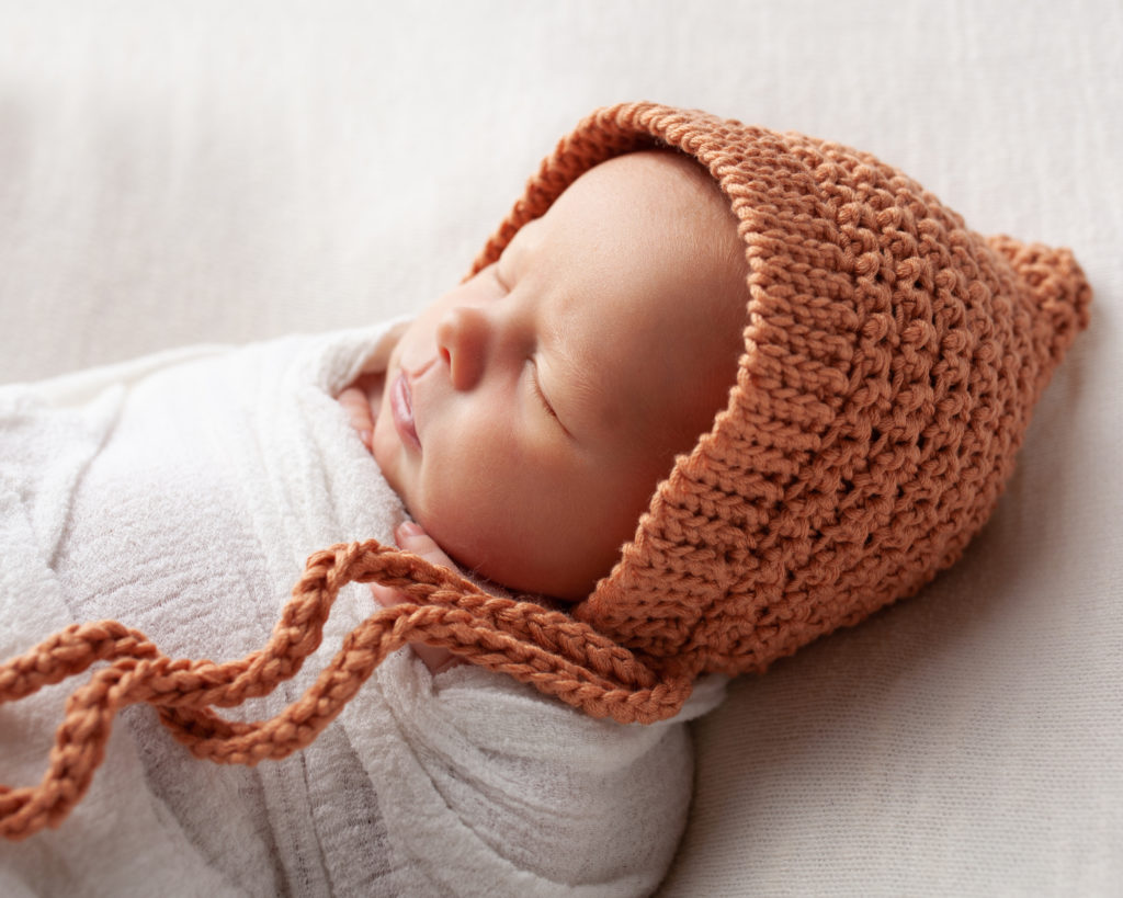 newborn with bonnet