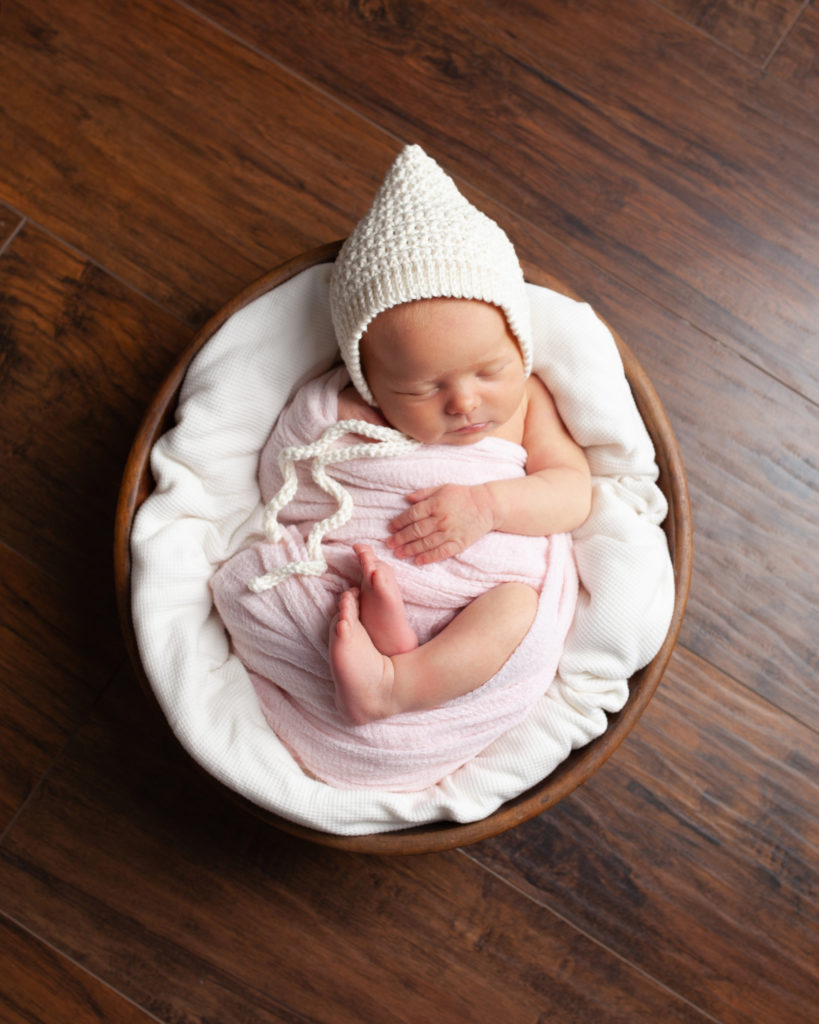 newborn swaddled in basket