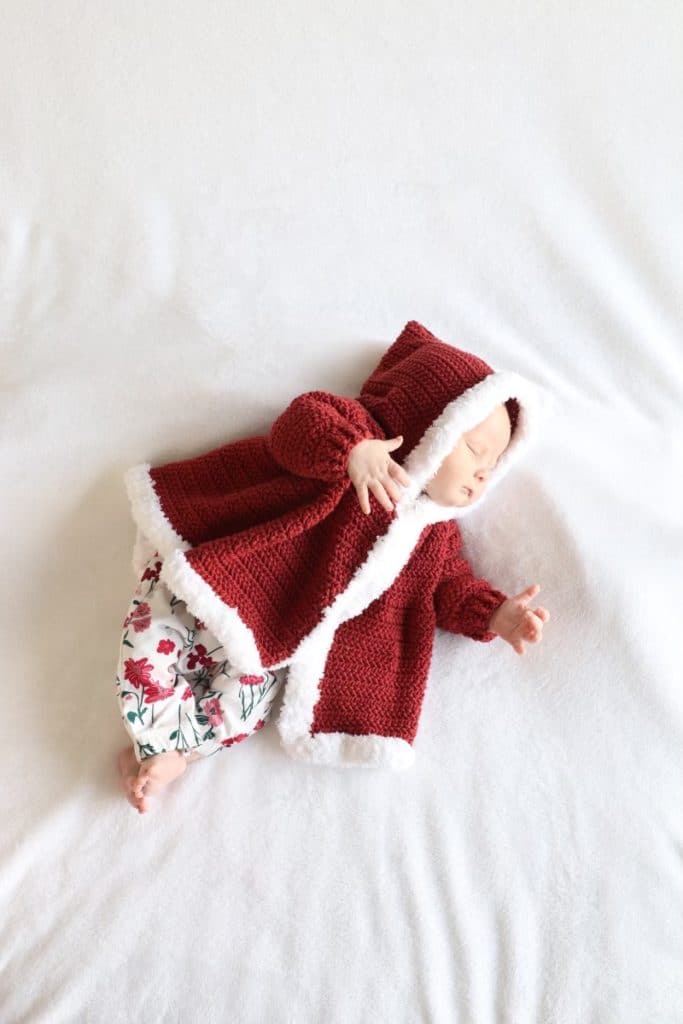 baby in red coat with white trim