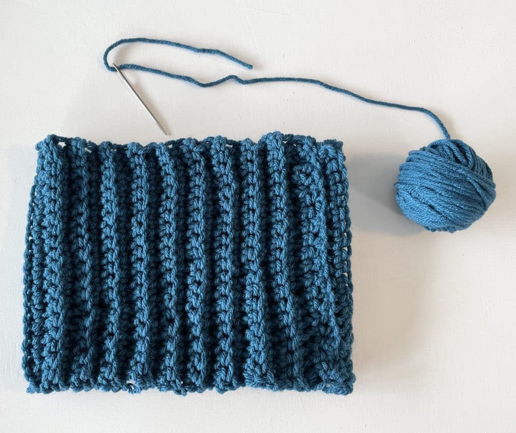 blue crochet yarn and turtleneck