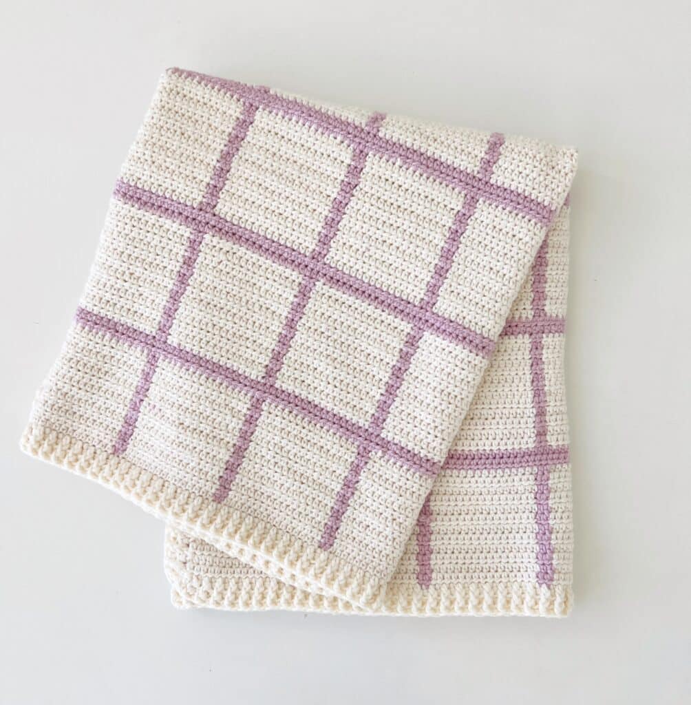Cream blanket with lavender stripes in a windowpane design