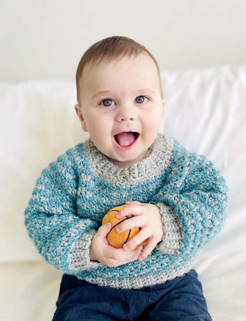 baby boy wearing crochet sweater