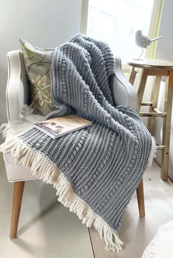crochet blanket draped across chair