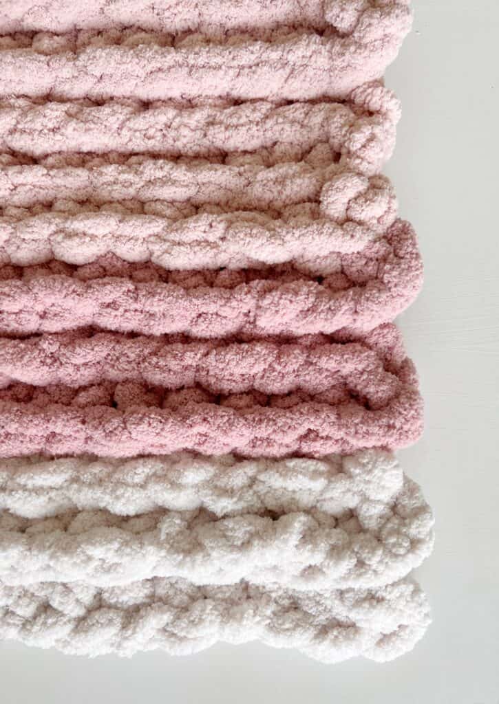 close up of pink and white yarn of crochet blanket