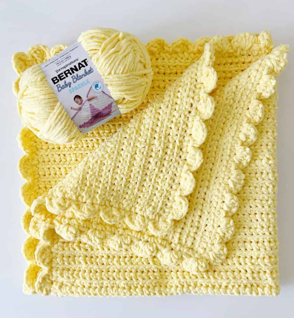 yellow crochet blanket flat lay