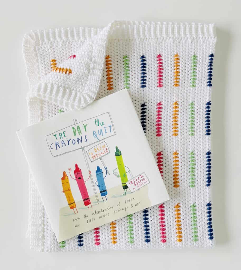 crochet blanket with children's book on top