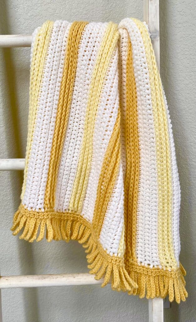 yellow crochet blanket with ladder