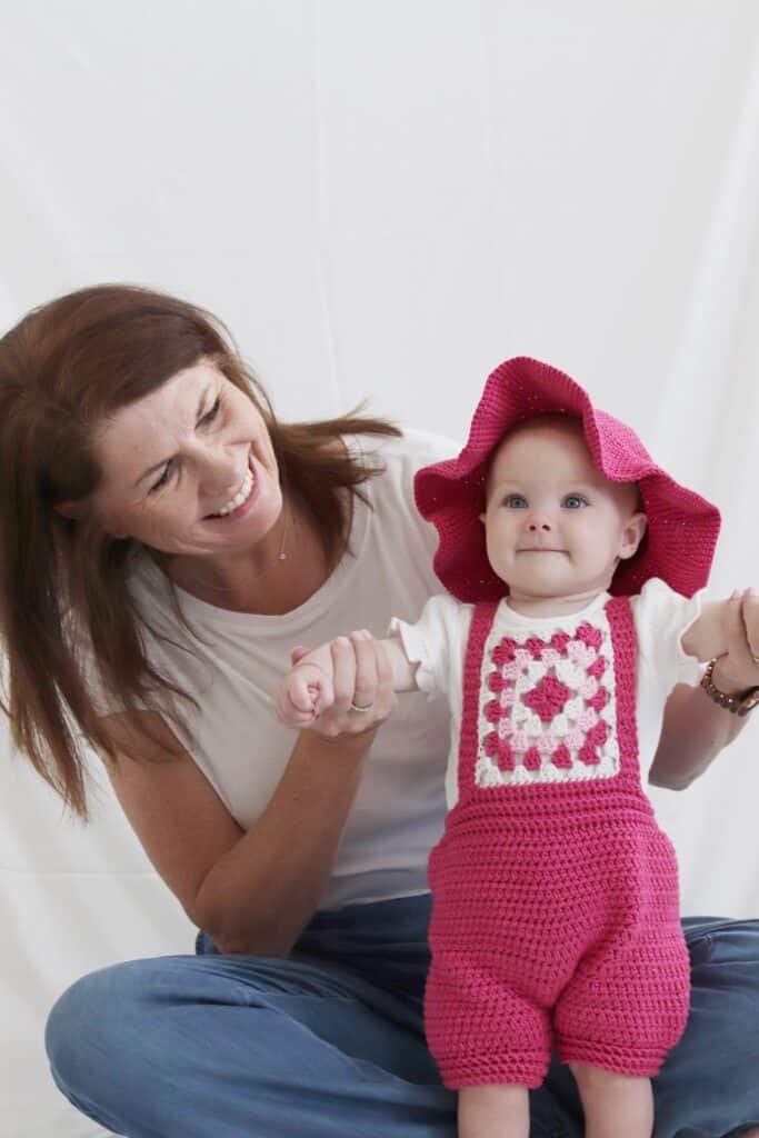 Woman with baby girl in crochet outfit