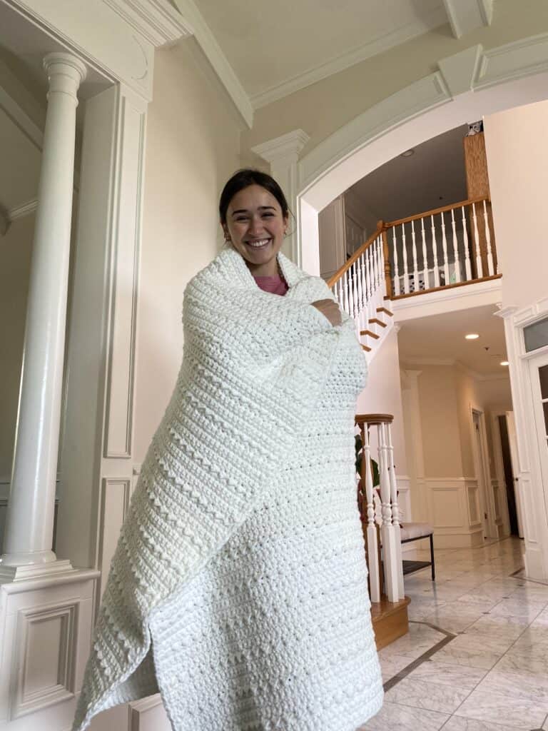 woman wrapped in crochet blanket