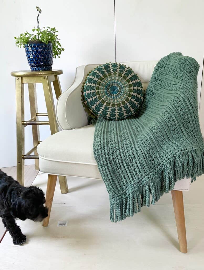 Crochet Throw on white chair with pillow
