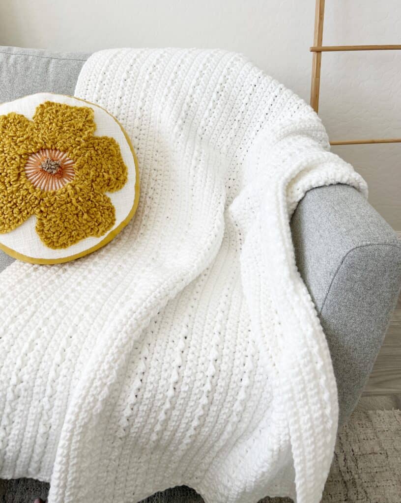 crochet blanket on the couch with pillow