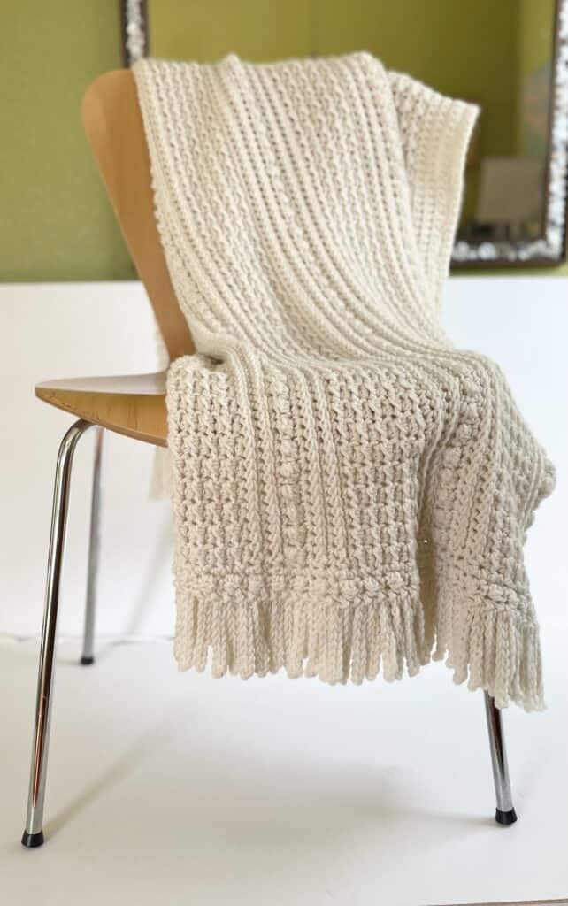 crochet blanket draped over chair