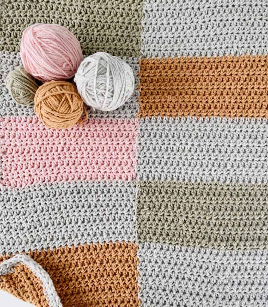 crochet blanket with balls of yarn