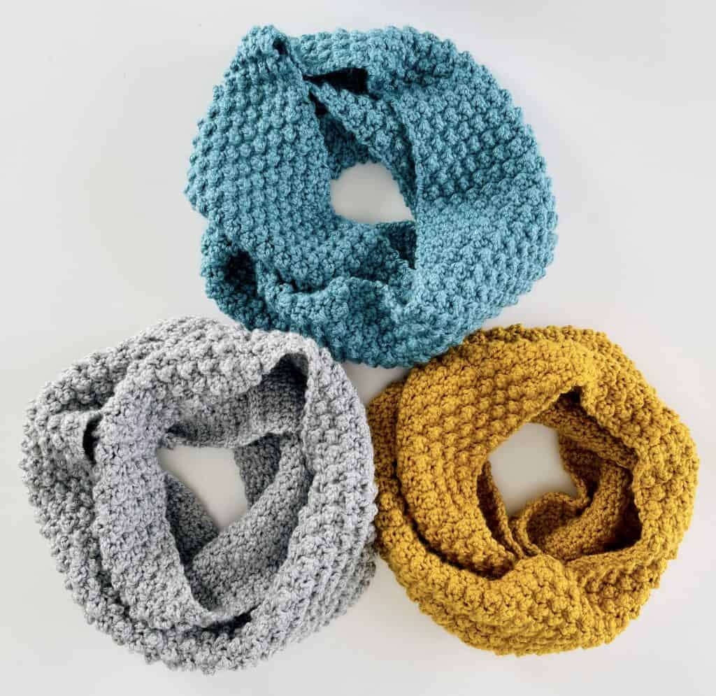 three scarfs; gray, blue, yellow