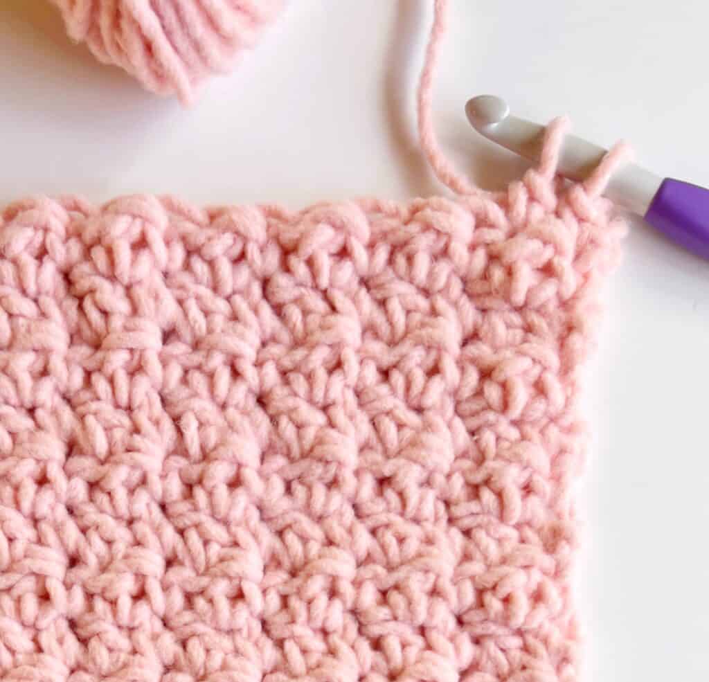 close up image of crochet swatch and hook