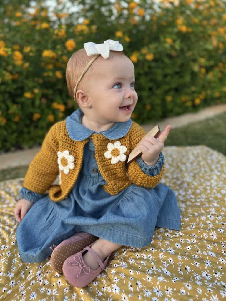 baby girl wearing yellow crochet sweater