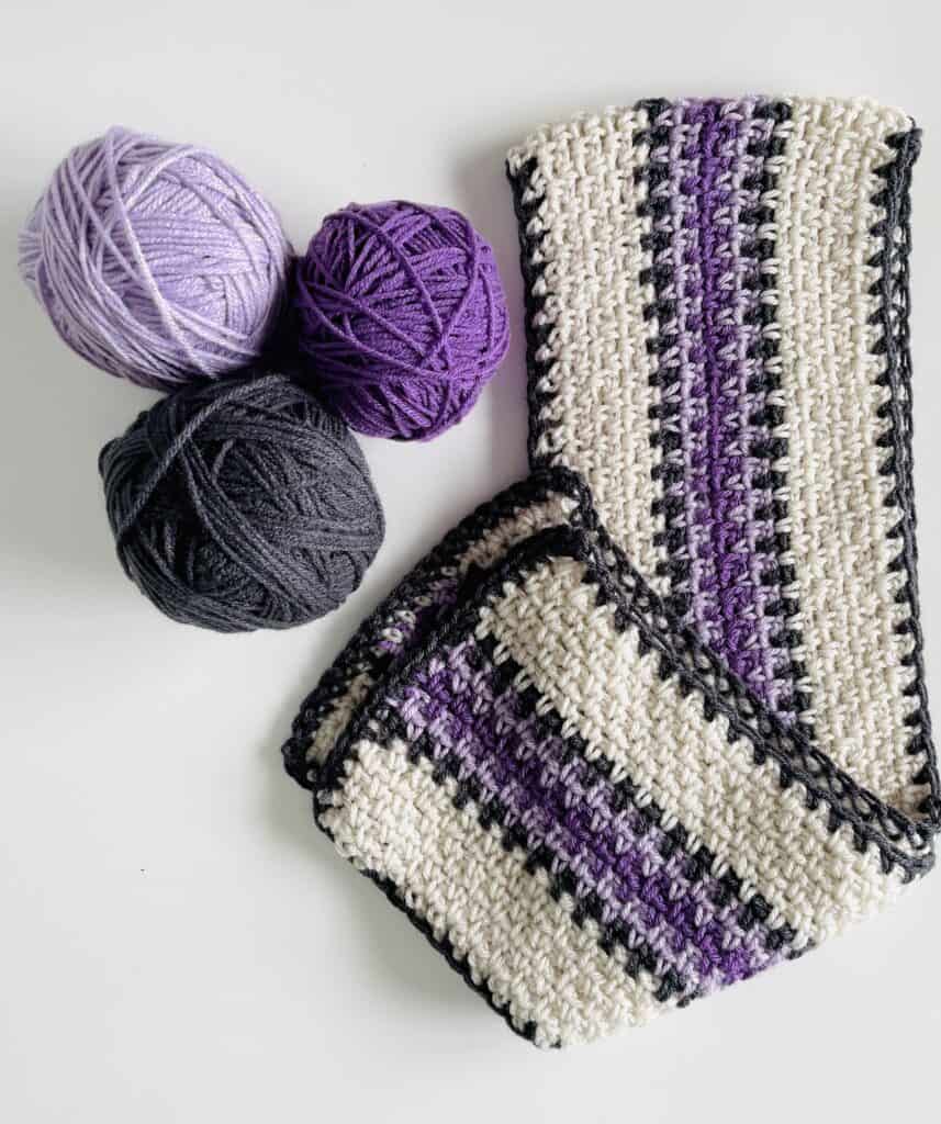 crochet scarf and 3 yarn balls