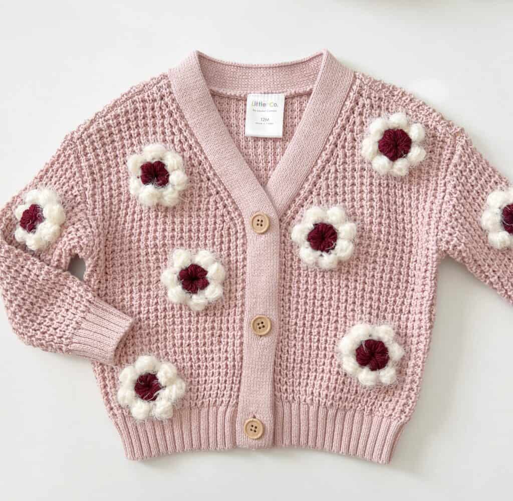 sweater with crochet flower embellishments