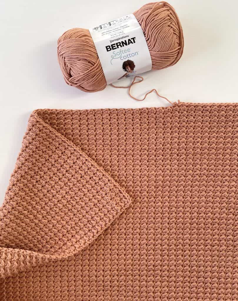 crochet blanket with skein of yarn