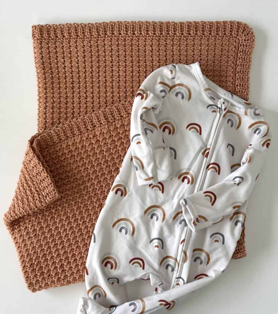 crochet blanket with baby onesie 