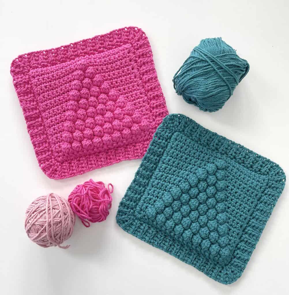 two crochet pads with yarn balls