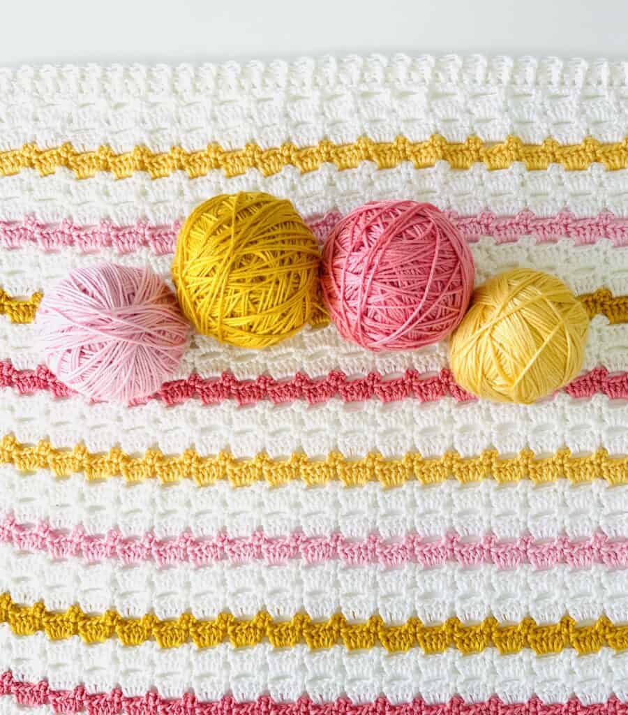 crochet blanket with yarn balls