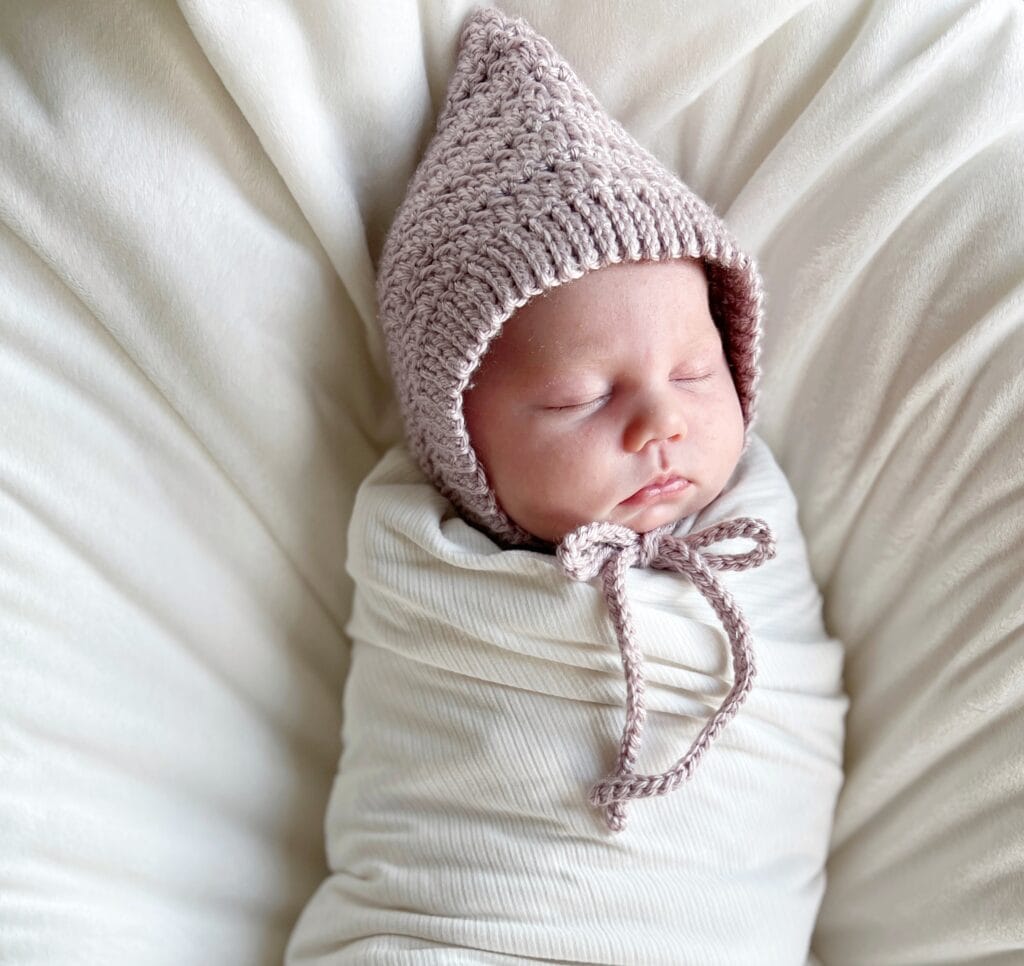 baby wearing baby bonnet