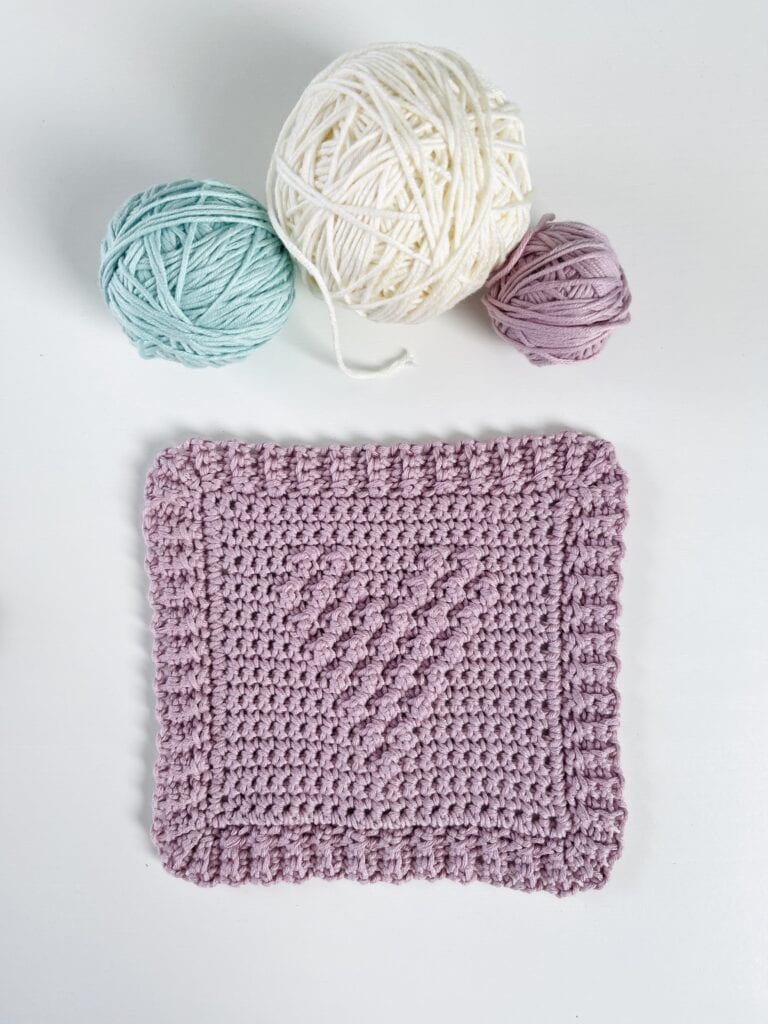 Crochet Dotted Baby Washcloths with yarn balls