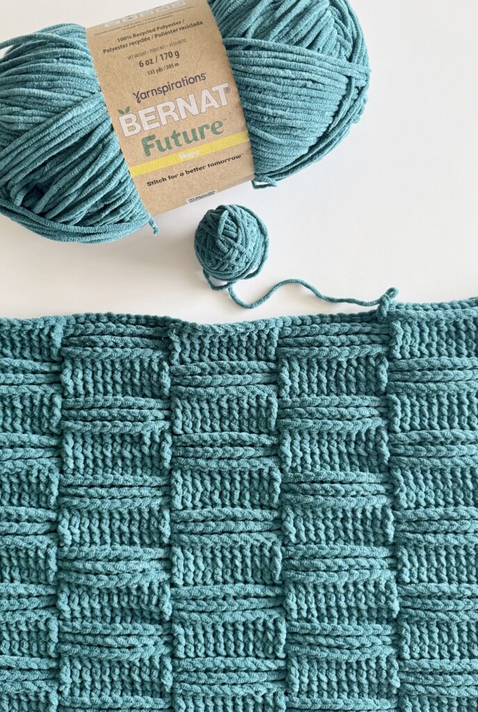 Blue basketweave crochet blanket with Bernat Future skein of yarn