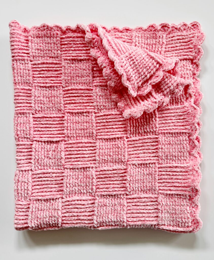 pink basketweave crochet blanket folded